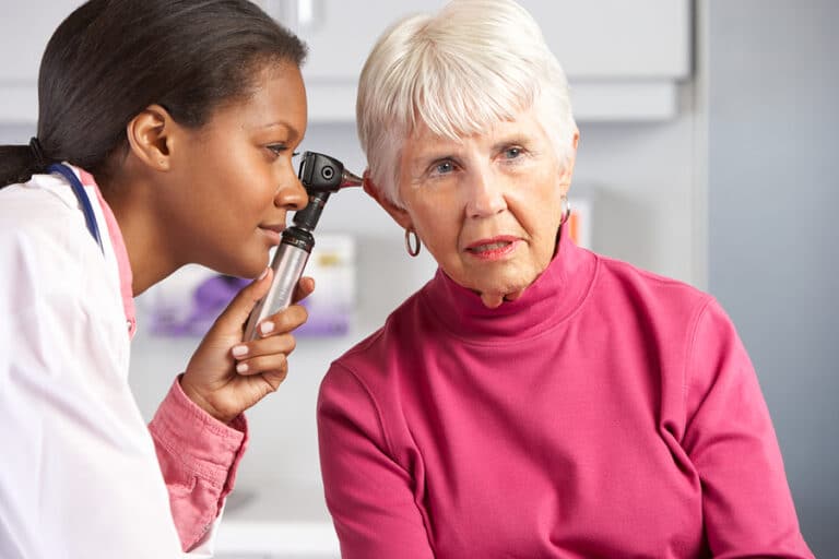 doctor examining elderly woman