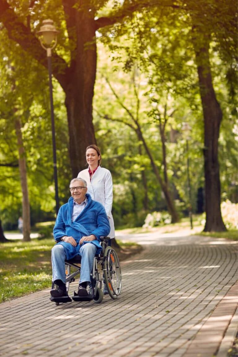 elderly man on wheelchair with caretaker