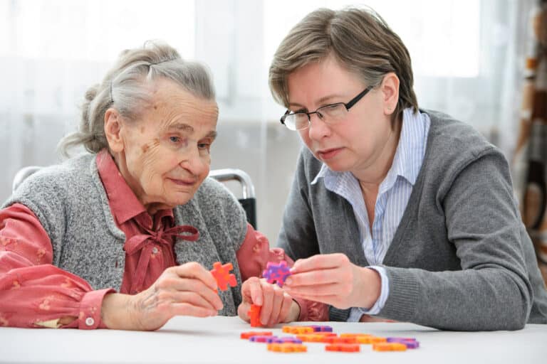 elderly woman doing a jigsaw puzzle