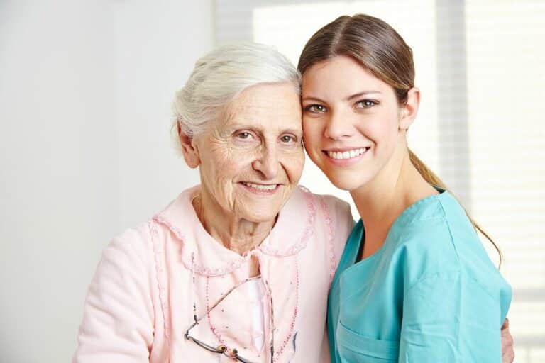 caregiver and elderly woman smiling