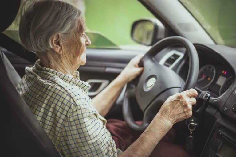 elderly people driving a car