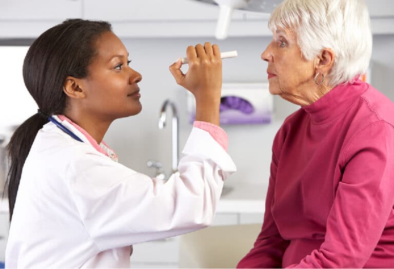 optometrist examining elderly person