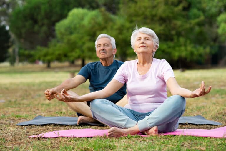 elderly people doing yoga