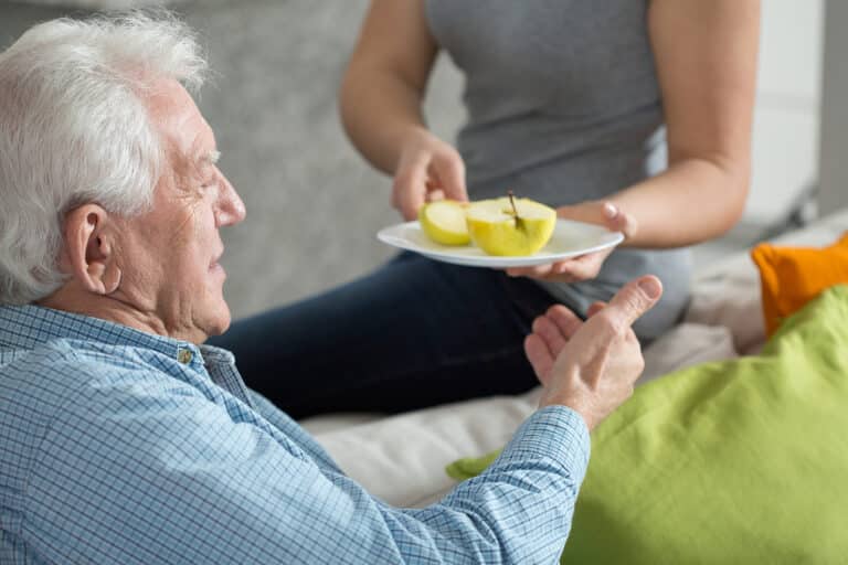 elderly people eating fruit